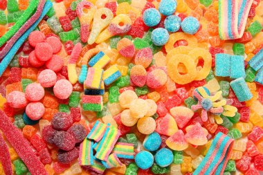 Assorted variety of sour candies includes extreme sour soft fruit chews, keys, tart candy belts and straws. clipart