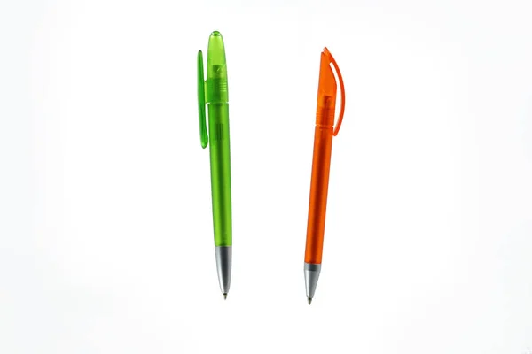 green and orange plastic ballpoint pen isolated on white background.