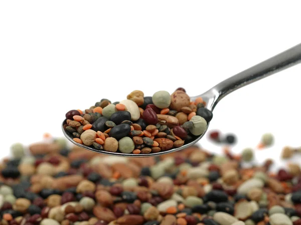 Variedad de ricas en proteínas coloridas legumbres en cuchara de plata con espacio para copiar, primer plano —  Fotos de Stock