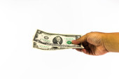 Nás dolar banka v rukou člověka izolovaných na bílém pozadí