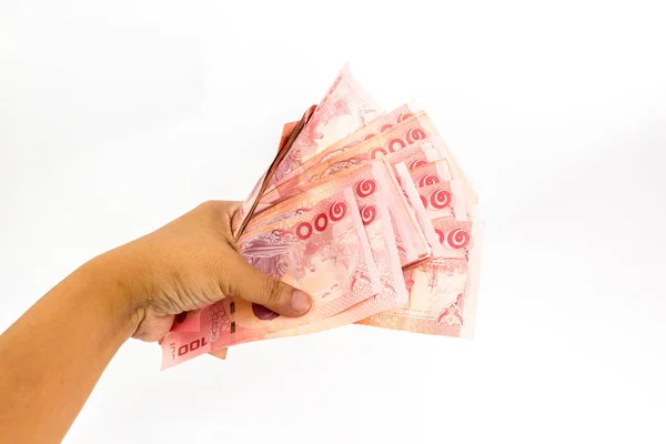Beyaz arka plan üzerinde izole adamın elinde Tayland banknotlar