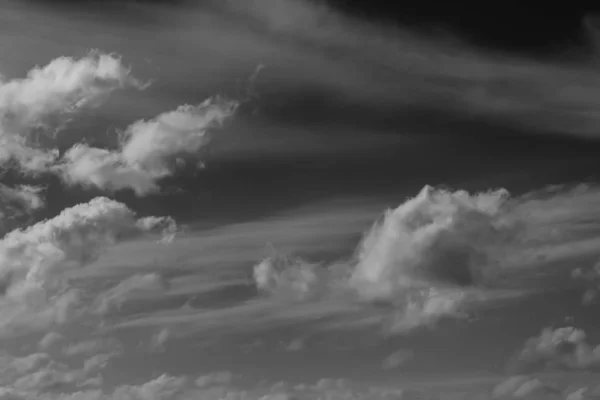white clouds on a dark sky, monochrome