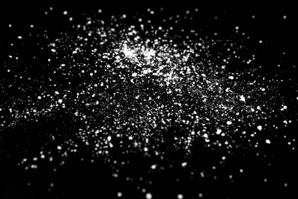  white crystalline powder on a black background. sugar dust