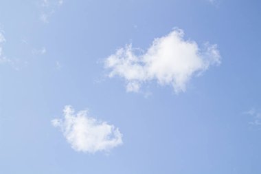 Mavi gökyüzüne karşı beyaz bulutlar.