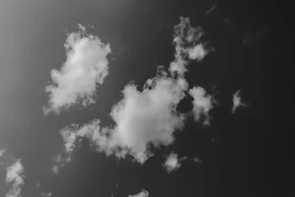 暗い空に向かう白い雲。モノクロ — ストック写真