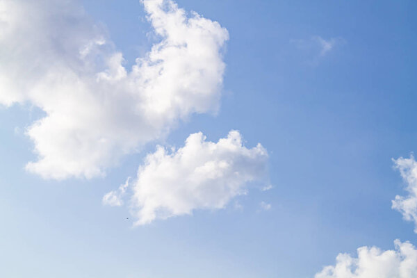 white clouds against the blue sky.