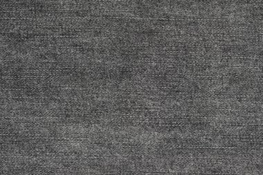 Örgü yün kumaş arka planının siyah doğal dokusu. Koyu gri pamuk kumaş, örülmüş tuval dokusu
