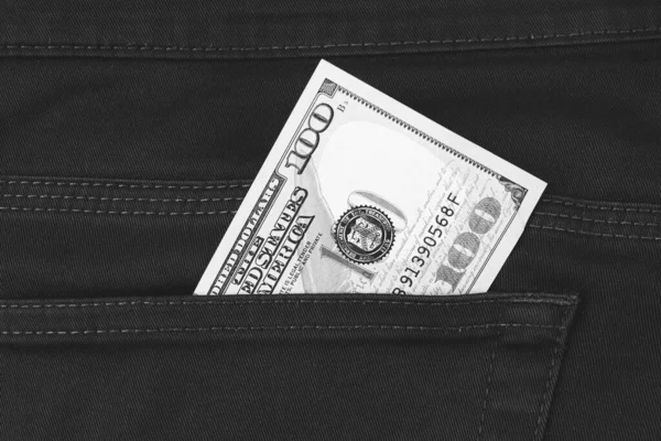 One hundred dollar banknote money in pocket trouser pants background texture. dollar bill close up