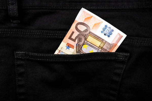 Fifty euro banknote money in pocket jeans pants background texture. 50 euro close up