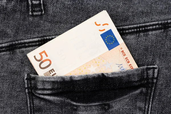 Fifty euro banknote money in pocket jeans pants background texture. 50 euro close up