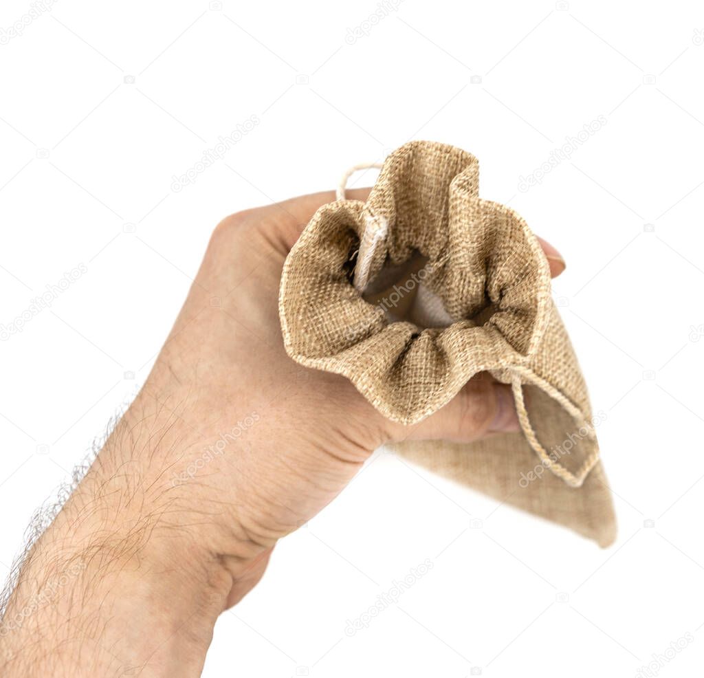 Holding male hand burlap gift bags on isolated white background