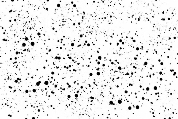 Drops of black paint splattered on a white background, texture