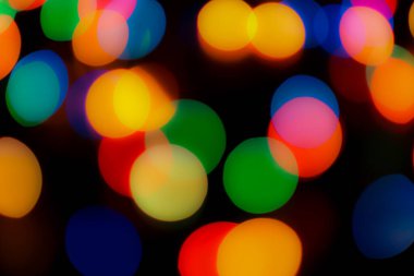 Soyut renkli, odaklanmış dairesel fakül. Bokeh bulanık renk ışığı arka planı kullanabilir. Yeni yıl Bokeh feshi