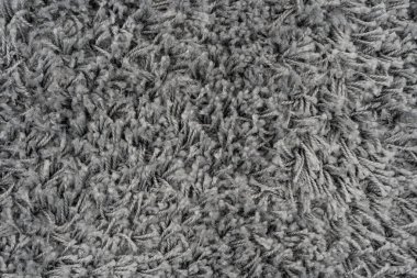 Siyah doğal yün halı dokusu. Koyu renk yün kumaş. Parça gri tüylü paspas