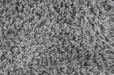 Siyah doğal yün halı dokusu. Koyu renk yün kumaş. Parça gri tüylü paspas