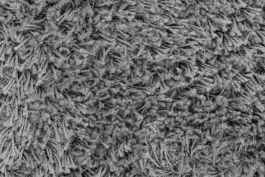 Siyah doğal yün halı dokusu. Koyu renk yün kumaş. Parça gri tüylü paspas