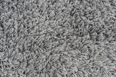 Siyah doğal yün halı dokusu. Koyu renk yün kumaş. Parça gri tüylü paspas
