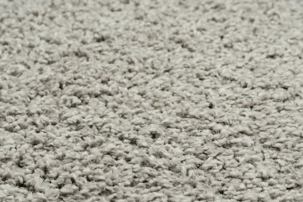 White natural fleece carpet texture background. Wool fabric texture fragment shaggy mat