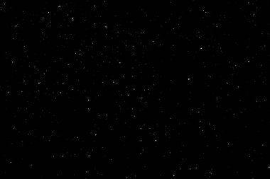 Siyah arka planda beyaz bir bokeh. Işık lekesi dokusu. Kar yağıyor. yıldız gökyüzü.