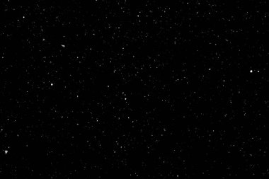 Siyah arka planda beyaz bir bokeh. Işık lekesi dokusu. Kar yağıyor. yıldız gökyüzü.