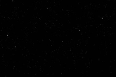 Siyah arka planda beyaz bir bokeh. Işık lekesi dokusu. Kar yağıyor. yıldız gökyüzü.