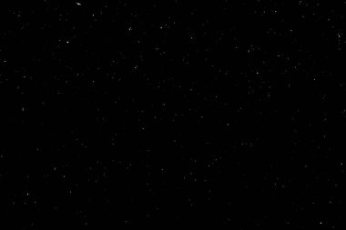 Siyah arka planda beyaz bir bokeh. Işık lekesi dokusu. Kar yağıyor. yıldız gökyüzü.