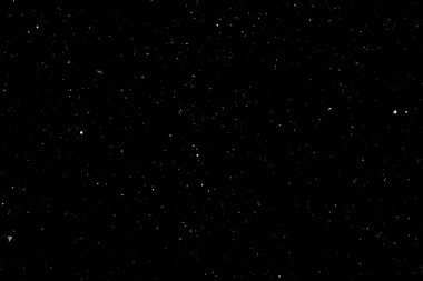 Siyah arka planda beyaz bir bokeh. Işık lekesi dokusu. Kar yağıyor. yıldız gökyüzü.