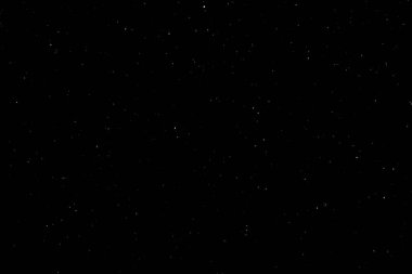 Siyah arka planda beyaz bir bokeh. Işık lekesi dokusu. Kar yağıyor. yıldız gökyüzü.