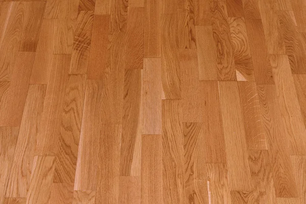 ブラウンラミネートの床の質感の背景 天然木の研磨面の寄木細工 — ストック写真