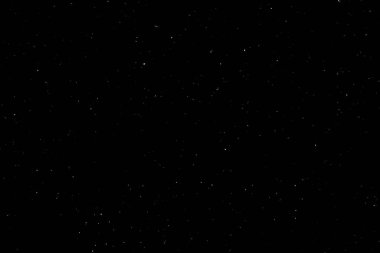 Siyah arka planda beyaz bir bokeh. Işık lekesi dokusu. Kar yağıyor. yıldız gökyüzü