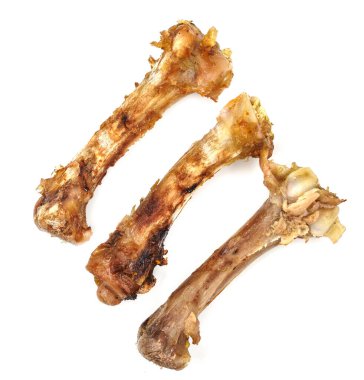 Beyaz arka planda küçük kemikler. Yemek artıkları. tavuk kemikleri