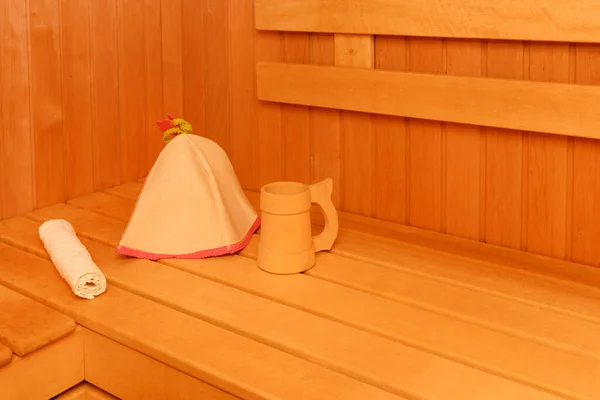 Wooden empty sauna room interior as background. towel and hat for the sauna