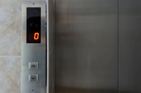 Metallic elevator panel with button and led display.  Interior and closeup of metal buttons in elevator