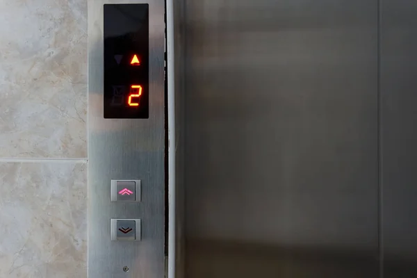 Metallic elevator panel with button and led display.  Interior and closeup of metal buttons in elevator