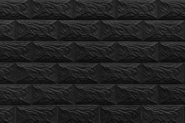 Tuğla işçiliği arka planından yapılmış siyah dekoratif duvar.