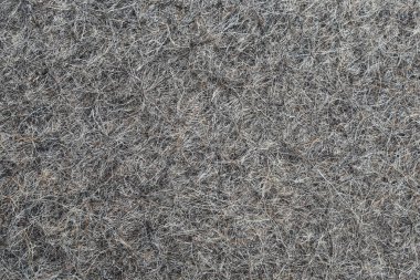 Çıkan saçlar arka plan dokusunu yakından hissettiriyordu. Keçeli çizmeler için koyun yünü