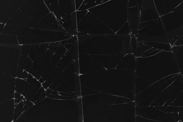 Black cracked glass texture background. Crack on the glass. Broken screen. Broken dark phone.  White cracks in glass