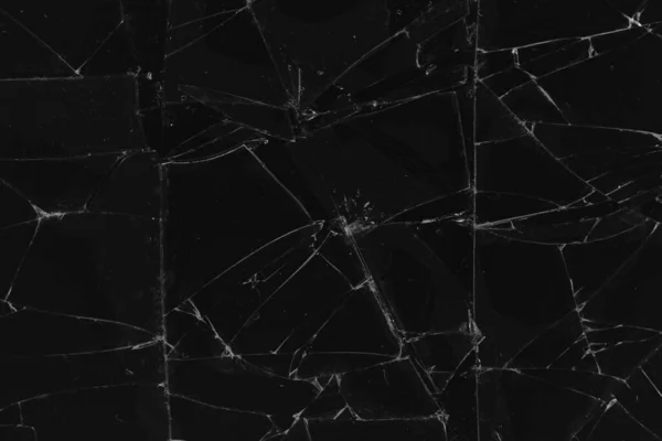Black cracked glass texture background. Crack on the glass. Broken screen. Broken dark phone.  White cracks in glass