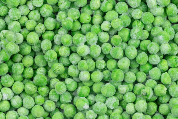 冷凍緑のエンドウ豆のテクスチャの背景 氷のエンドウ豆の背景です 生野菜 — ストック写真