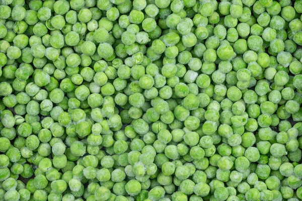 冷凍緑のエンドウ豆のテクスチャの背景 氷のエンドウ豆の背景です 生野菜 — ストック写真