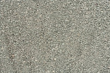 Gri küçük kayaların zemin dokusu. Siyah küçük yol taşı arka planı. Taş çakıl taşları, dikişsiz doku. Ezilmiş granit çakılların koyu arkaplanı, yakın plan. yığılan kil