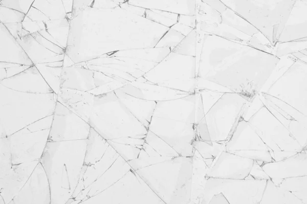 White cracked glass texture background. Texture broken glass window with cracks. Broken screen.