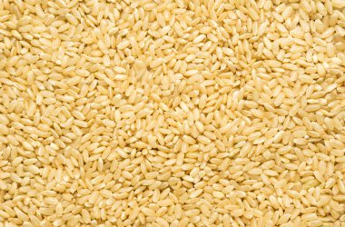 Kahverengi pirinç arkaplan dokusu, sarı uzun tahıl doğal pirinç, yasemin pirinci yakın plan.