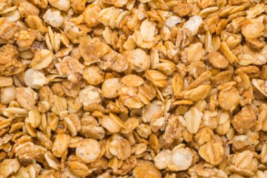 Fırınlanmış sarı müsli arka plan, mısır gevreği dokusu yakın çekim