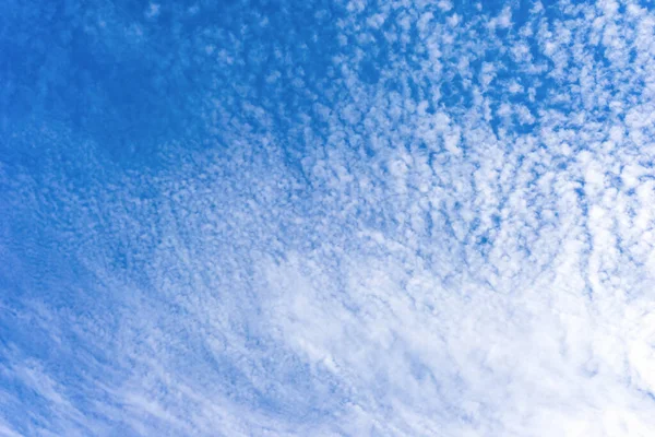 White clouds on a blue sky on a sunny day background texture