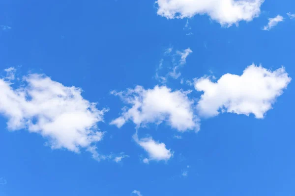 White clouds on a blue sky on a sunny day background texture