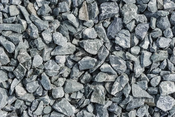 Road stones gravel texture, rocks for construction, background of crushed granite gravel, small rocks, closeup