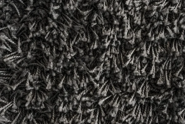 Black shaggy carpet texture, rug with short wool background