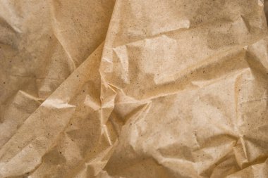 Kahverengi ambalaj kağıdı arka planı, sarı kırışık eski kağıt, kağıt yüzeyinde kırışıklıklar.