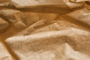 Kahverengi ambalaj kağıdı arka planı, sarı kırışık eski kağıt, kağıt yüzeyinde kırışıklıklar.